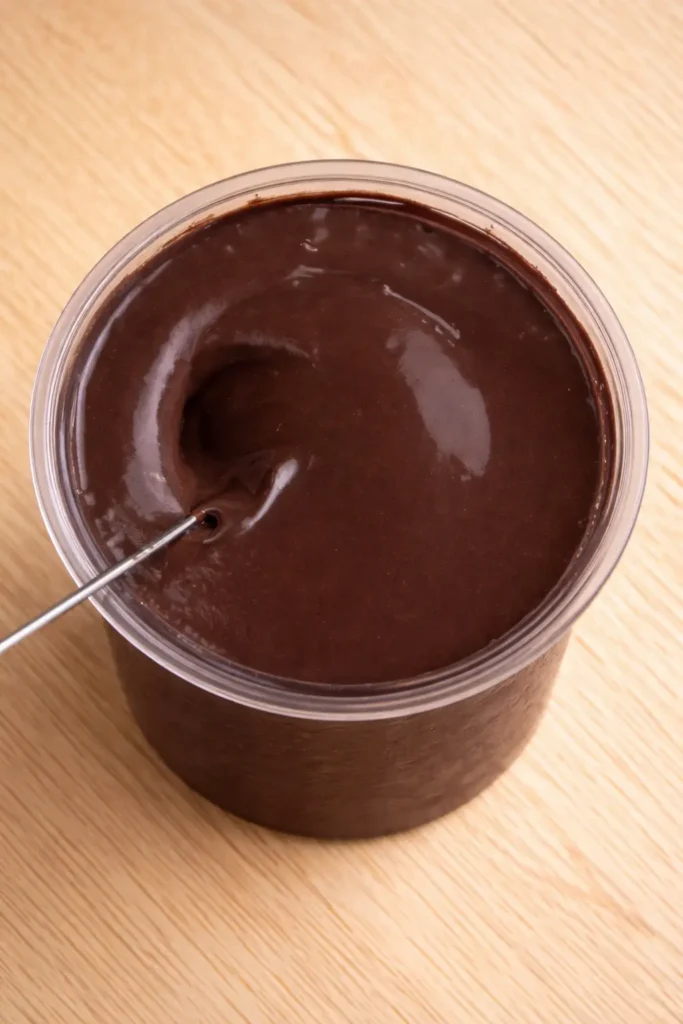 someone blending a Cosmic brownie ninja creamie ice cream with  a handheld blender